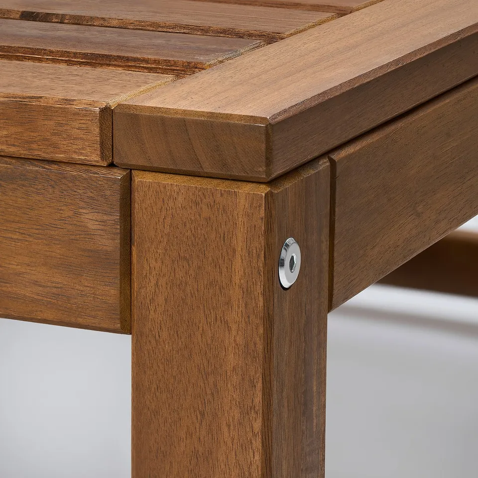 Close-up of high-quality acacia wood furniture, showing smooth finish and robust joinery.