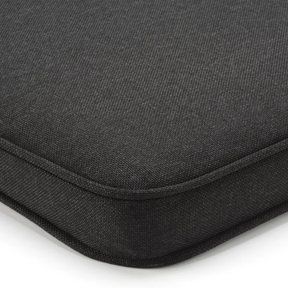 Black outdoor chair cushion with textured, durable fabric and neat stitching, designed for comfort and longevity.