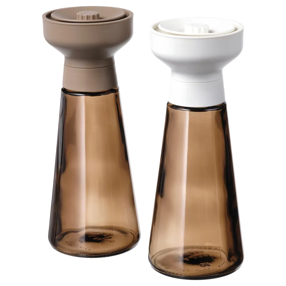 Brown glass spice jars with grinders.