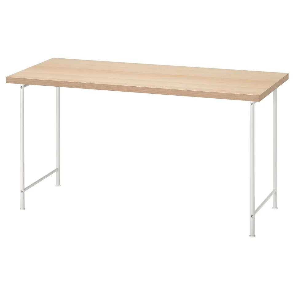 An IKEA LAGKAPTEN light wooden desk with white metal legs. The desk is rectangular with adjustable feet.