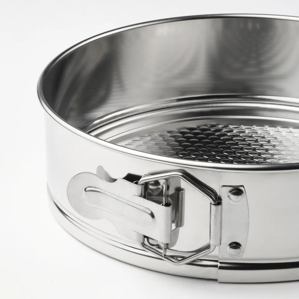 Close-up of a stainless-steel springform pan showcasing its smooth, even-heating surface and secure latch.