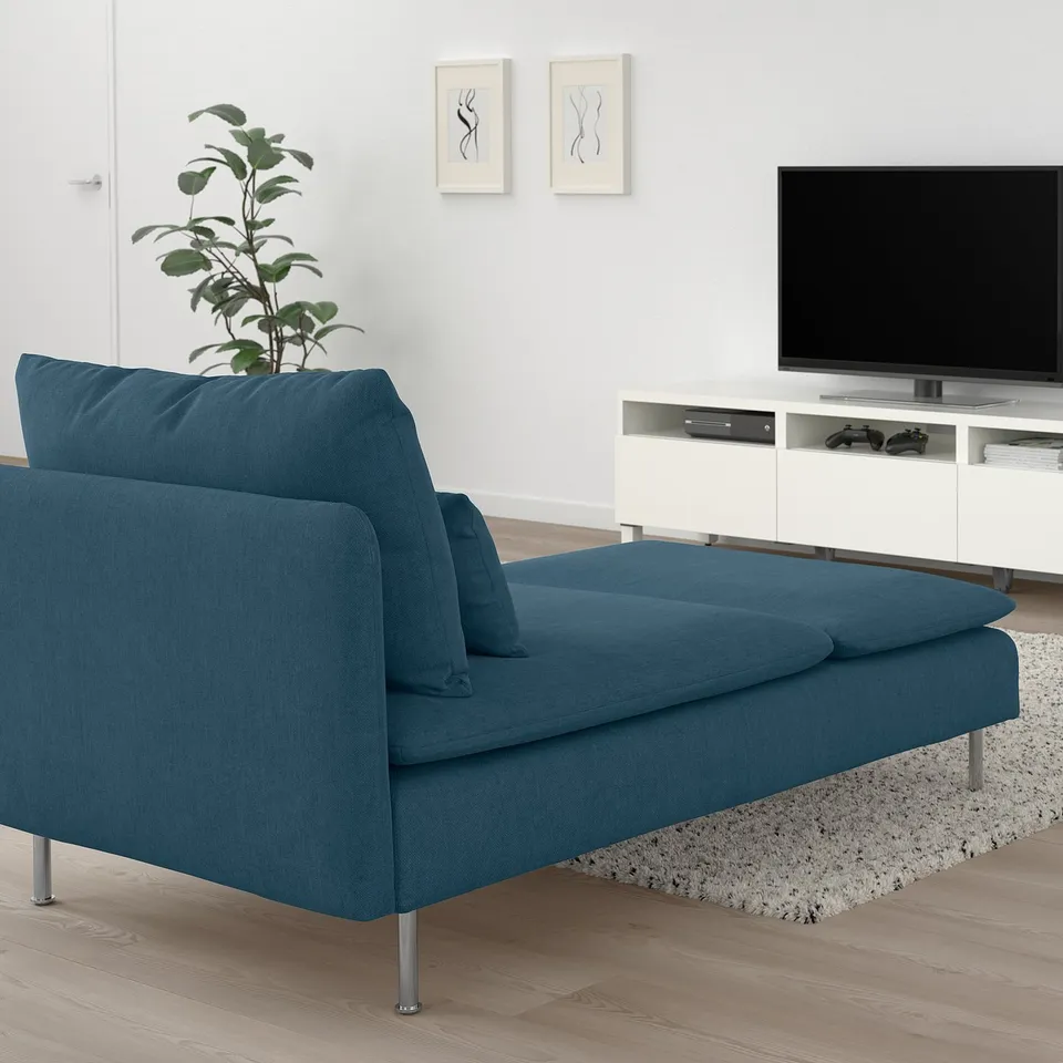 Modern living room with teal chaise, tv, plant, white cabinet, plush cushions, perfect for relaxing and watching movies.