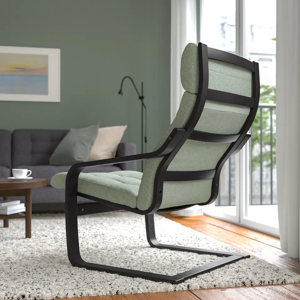 Modern living room with cushioned armchair and large window.