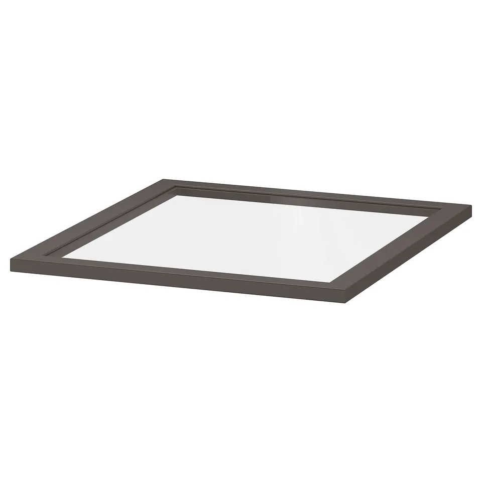A KOMPLEMENT glass shelf in dark grey. Its square-shaped with a fiberboard frame and tempered glass.