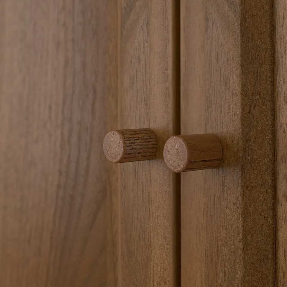 Wooden door with two cylindrical handles, showcasing a smooth, natural texture and high-quality craftsmanship.