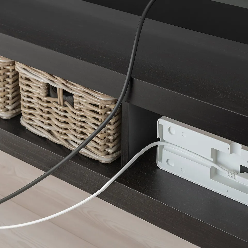 Image shows LACK tv bench with woven baskets and wire management.
