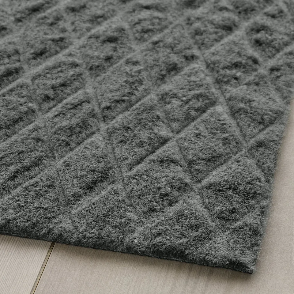 Close-up of textured, grey doormat with diamond pattern, showcasing high-quality material and intricate design.