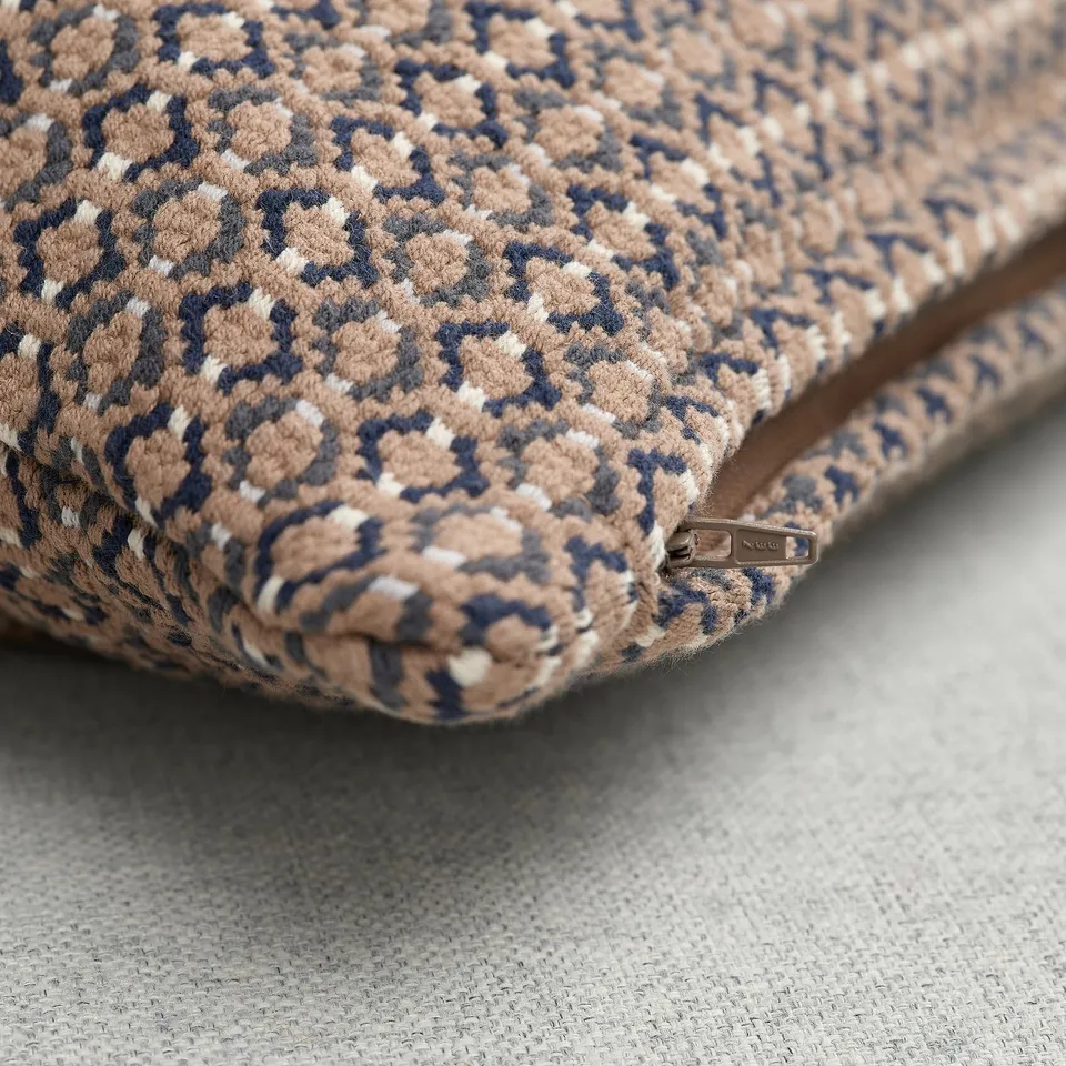 Soft, woven cushion cover with brown, beige, and white pattern. Zip detail for easy washing.