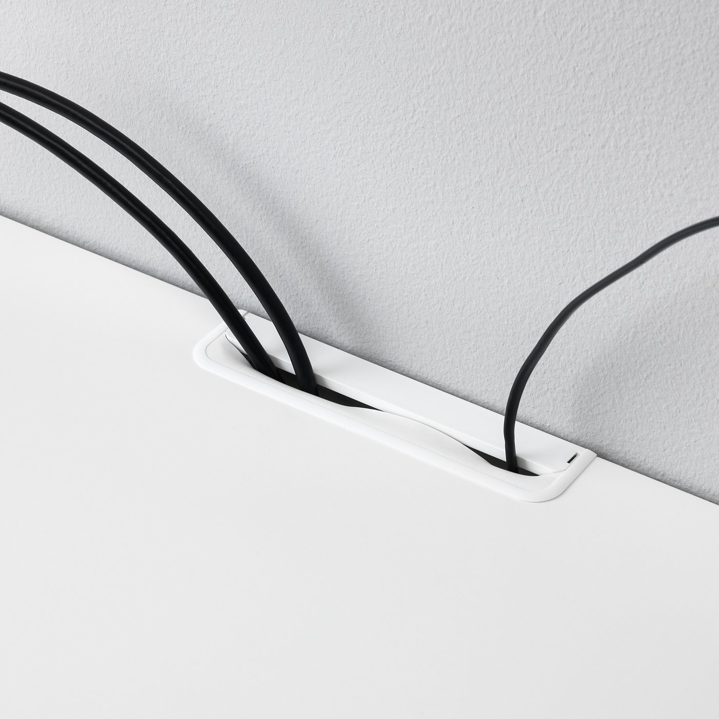 White tv bench with built-in cable management, showing cables neatly routed through a back cable outlet.