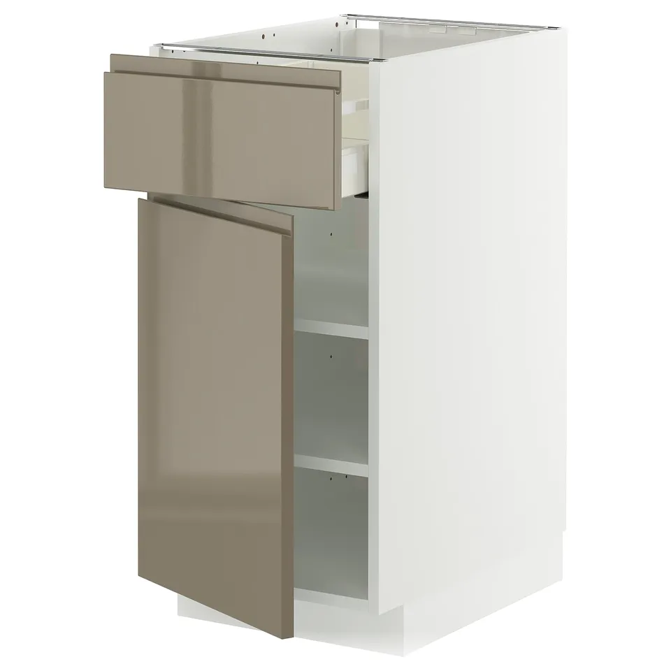 Modern white kitchen cabinet with bronze drawer and door, sleek and minimalist.