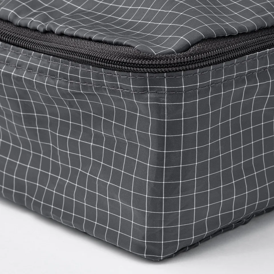 A square, grey rensfare organiser with a white grid pattern and strong black zip.