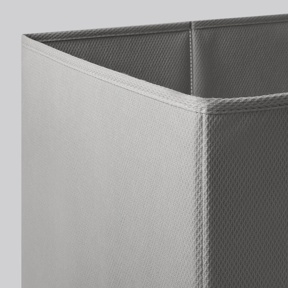 Foldable storage bin with white and grey fabric, sturdy construction.