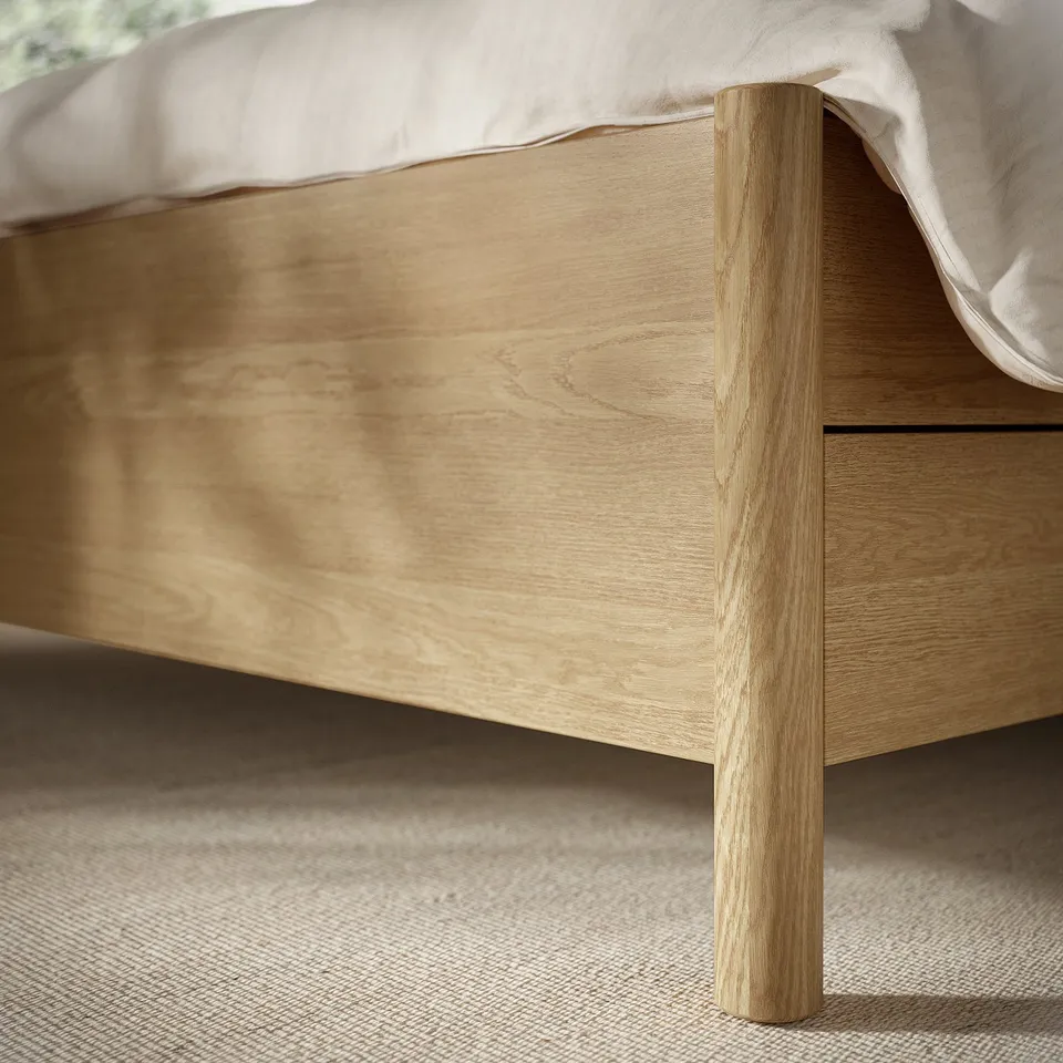 Wooden bed frame with light oak grain, soft-close drawers, sturdy craftsmanship.