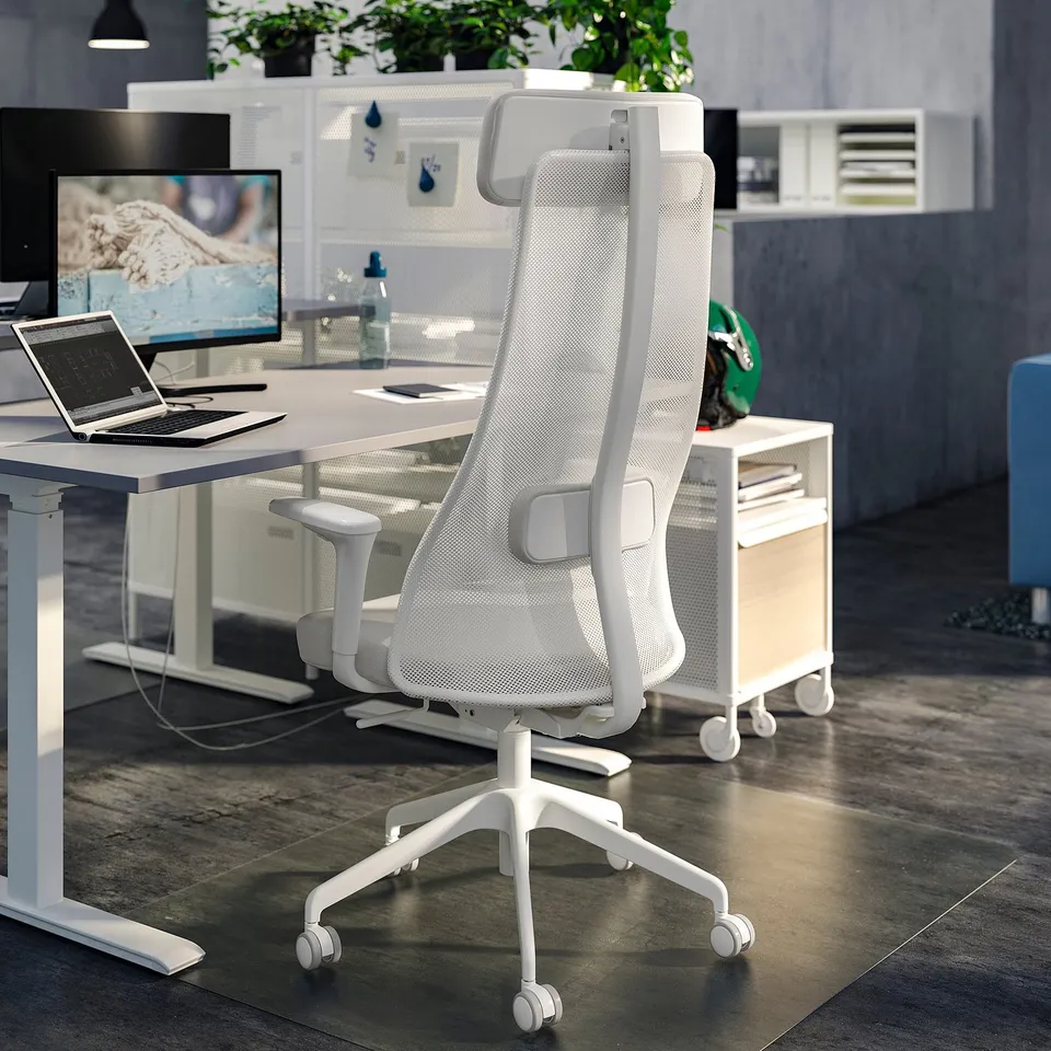 Modern office setup with white ergonomic chairs, desks, and tech equipment.