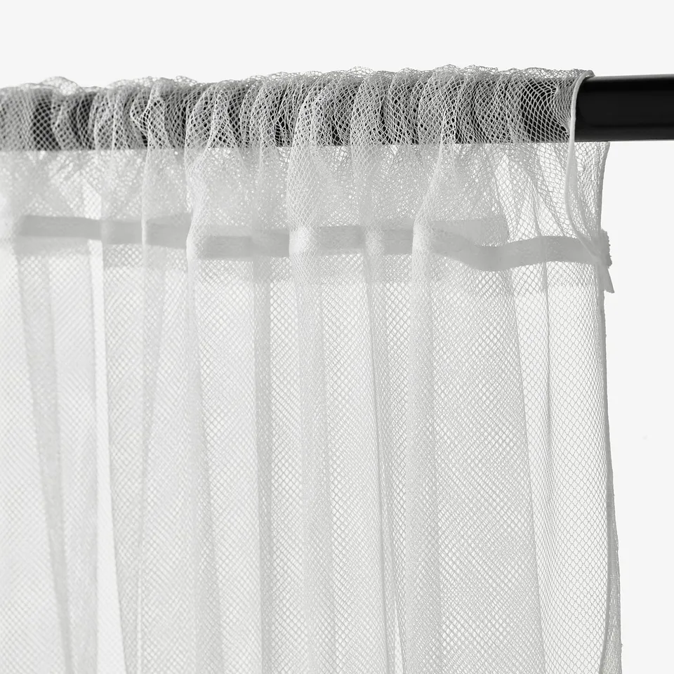 LILL net curtains hanging. Sheer fabric allows light and air in but keeps insects out.