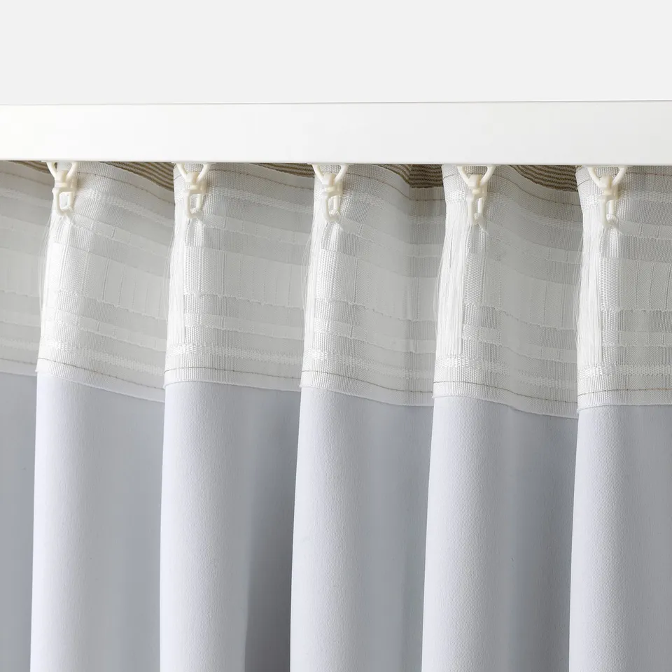 White curtains with heading tape hang, suitable for pleated look, keeping draughts out and heat in.