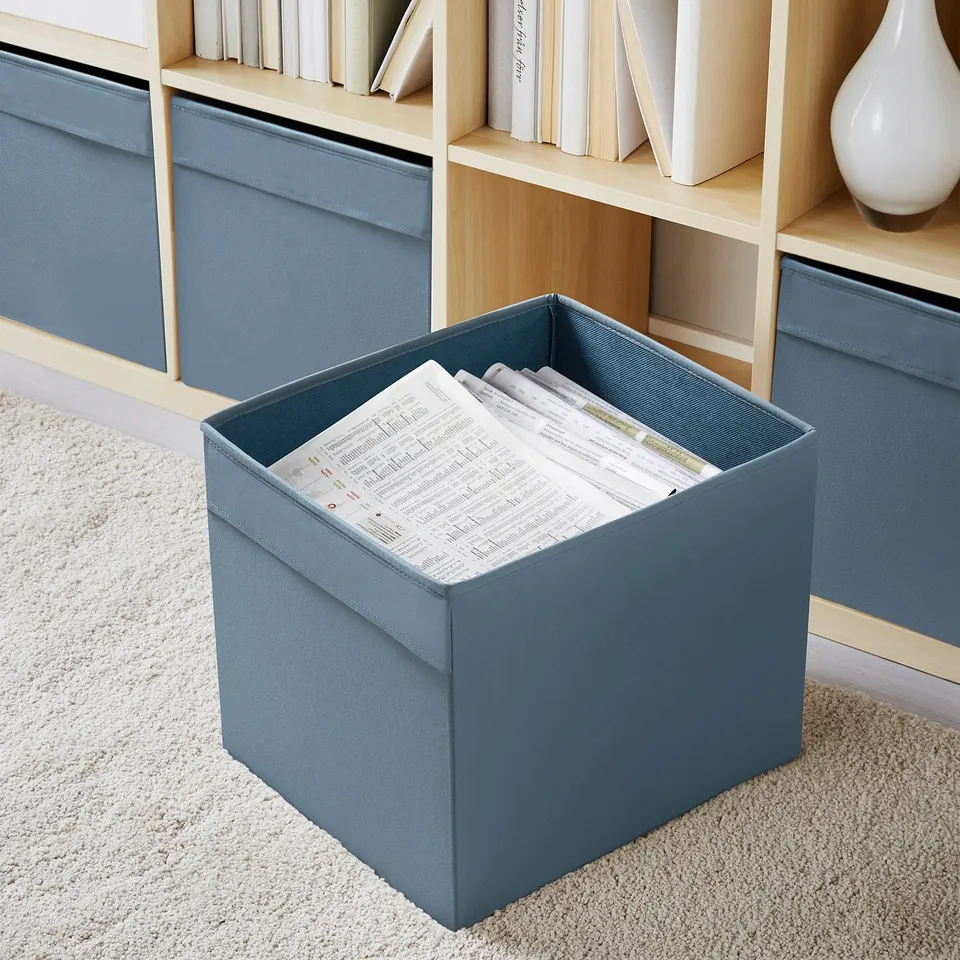 Blue DRÖNA boxes on kallax shelves, organising room with books and papers.