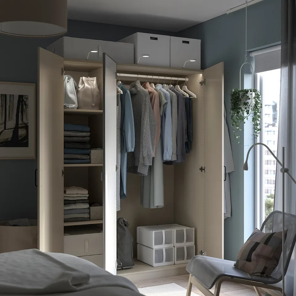 Open wardrobe with clothes, shelves, and storage boxes. The frame is beige, with grey and beige items inside.