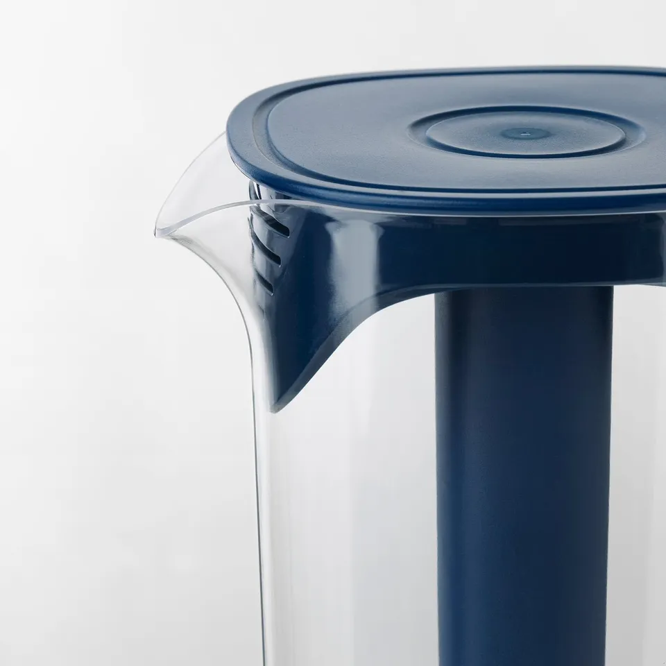 Clear plastic jug with blue lid and handle, designed for refreshing drinks. Sturdy and stylish for summer beverages.