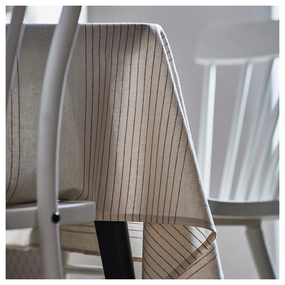 A beige striped cotton tablecloth by VIPPSTARR, featuring subtle lines and a natural, inviting look.