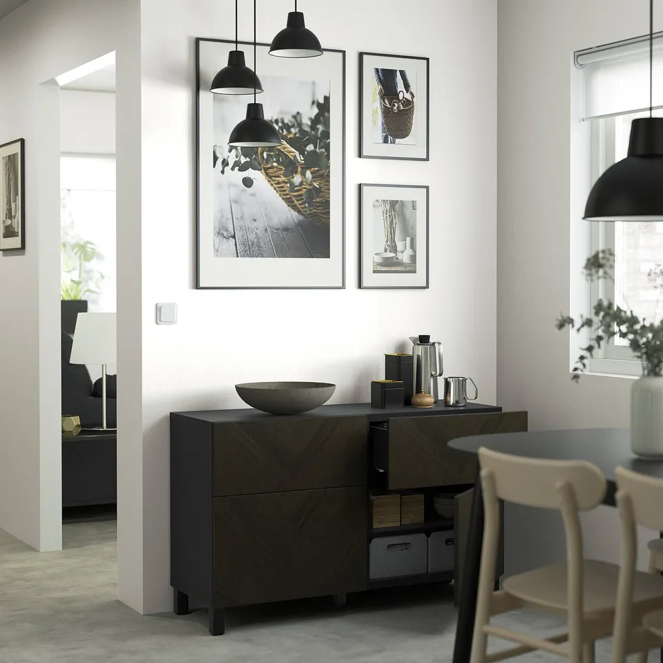 Modern living room with a BESTÅ sideboard, featuring adjustable storage, a bowl, and framed art above.