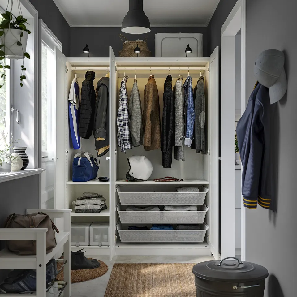 Open PAX wardrobe reveals clothes hangers, storage drawers, and shelves organised for easy access.