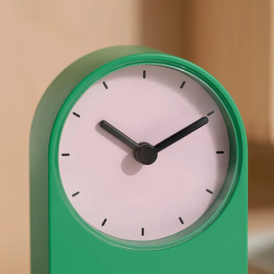 Modern green clock with sleek design; silent, minimalist style.