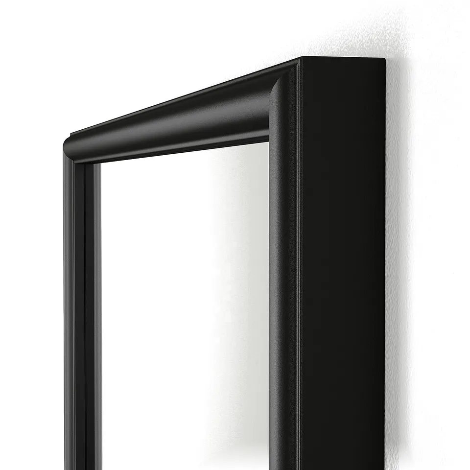 Modern black framed mirror with sleek design. High-quality finishes, robust construction.