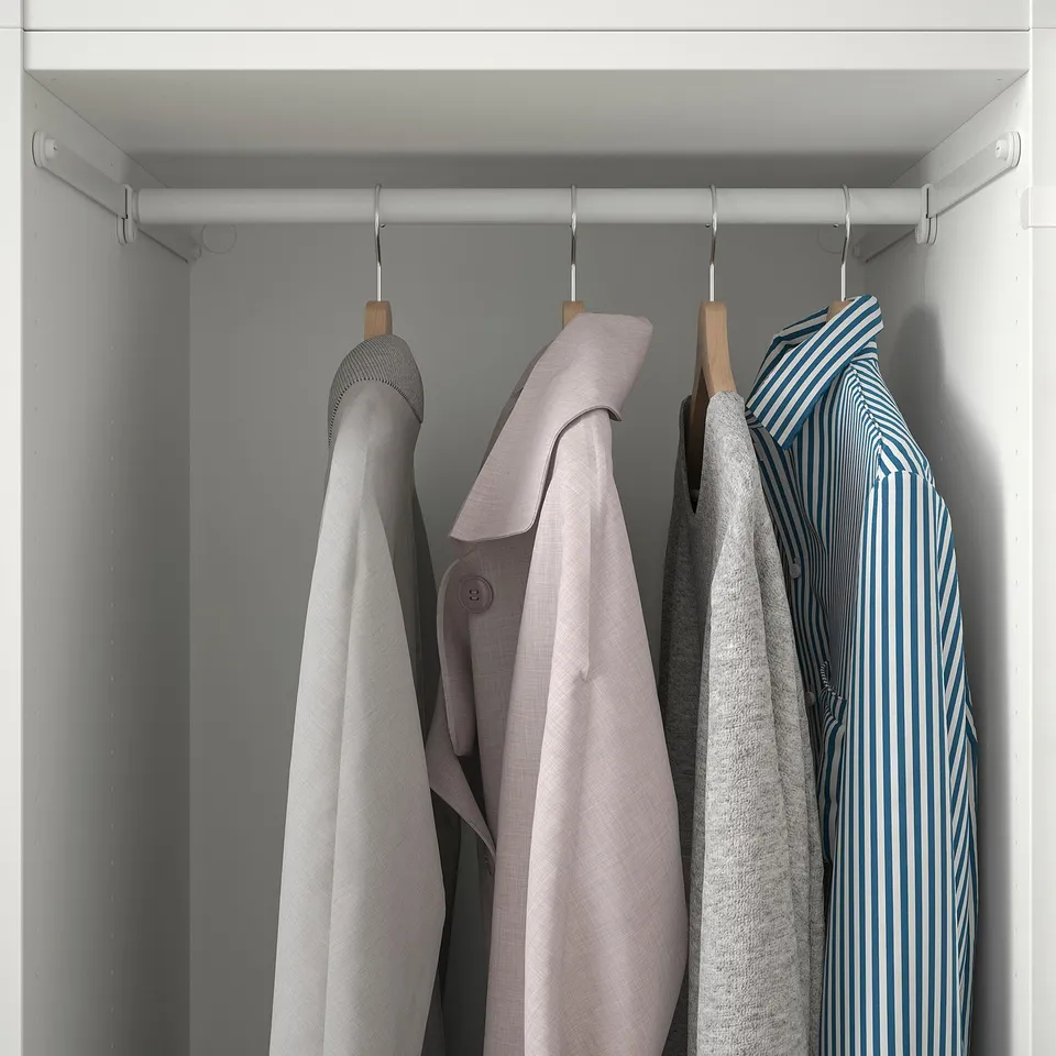 Closet with hanging rods holds several coats neatly on wooden hangers.