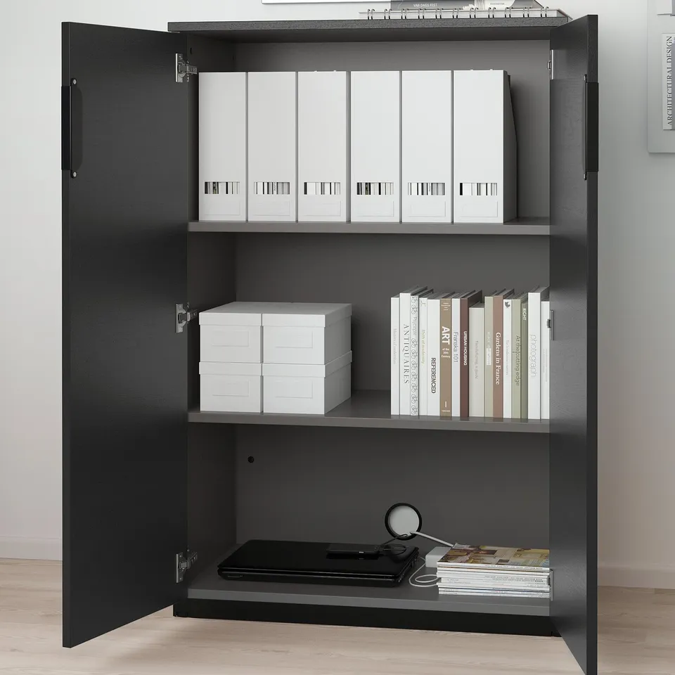 Black GALANT cabinet with 3 shelves: binders, boxes, papers, folders.