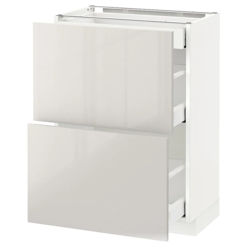 A white METOD kitchen cabinet with glossy, minimalist design and integrated drawers for storage.