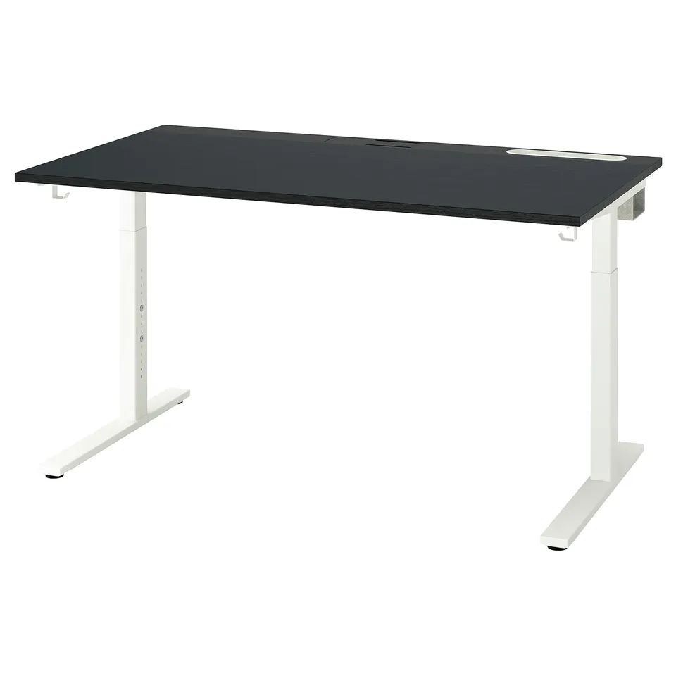 A black MITTZON height-adjustable desk with white legs. It has a sleek, modern design and can be elevated for sitting or standing.