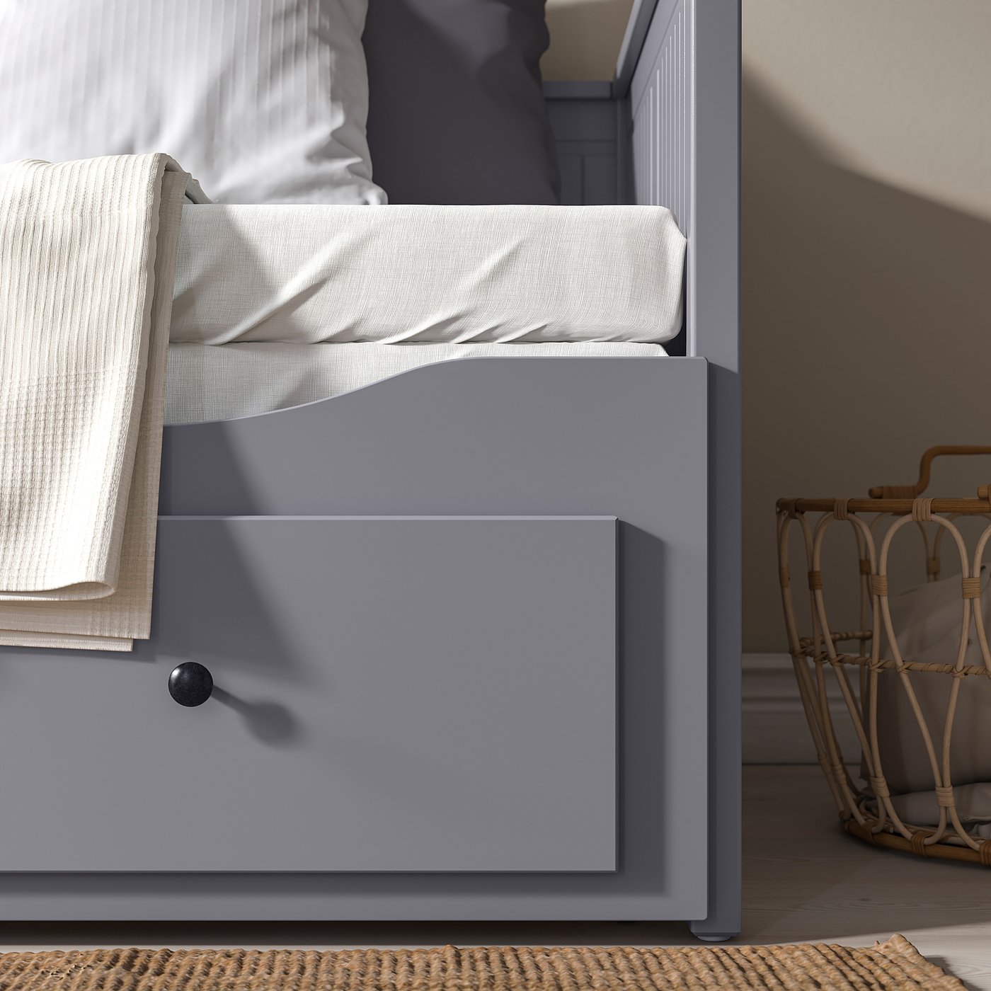 HEMNES day-bed with storage drawers, cosy high frame, white blanket.