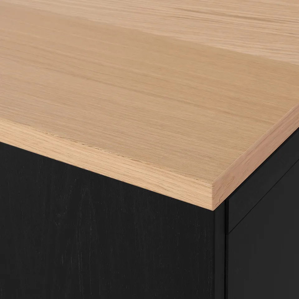 Close-up view of sleek wooden tabletop edge, showing smooth finish and precision craftsmanship.