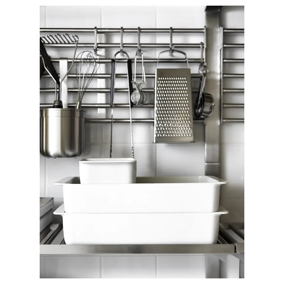 KUNGSFORS stainless-steel kitchen storage. Hooks hold utensils and metallic dishes, saving counter space. Wall-mounted, modern design.