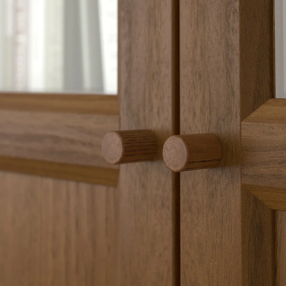 Close-up of BILLY bookcase with cylindrical wooden knobs. Smooth, quality finish on rich, natural wooden texture.