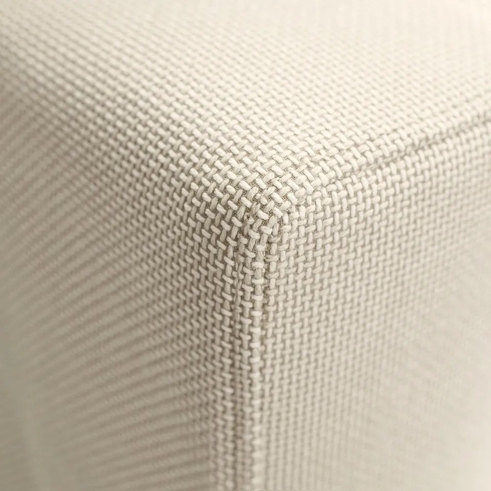 Close-up of high-quality sofa fabric; textured, woven beige material.
