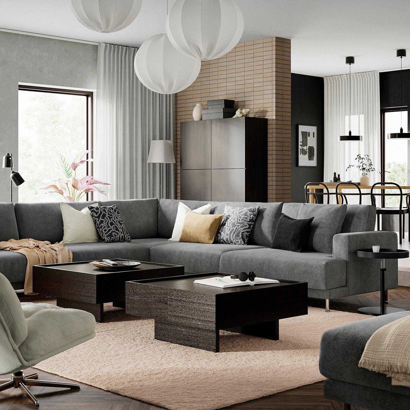 Modern living room with grey sofa, coffee table, rug, lamps, shelf.