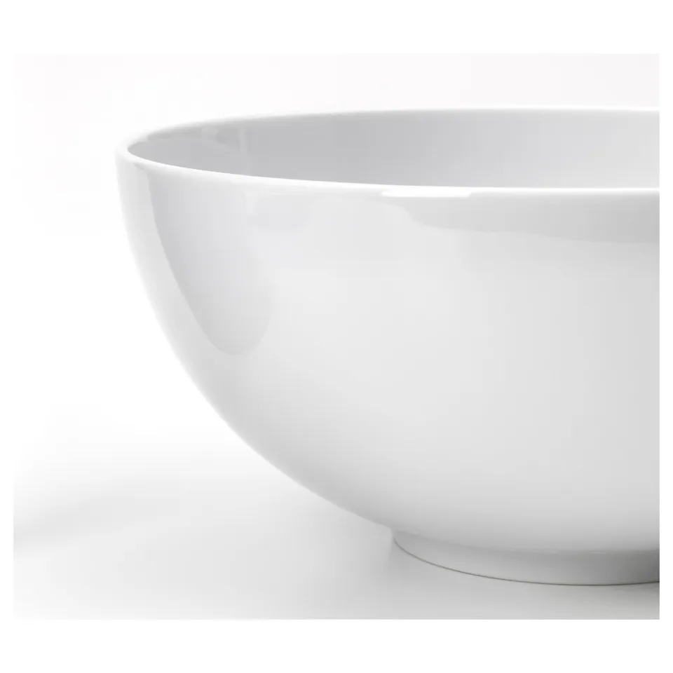 Close-up of ikea porcelain bowl, showcasing smooth, glossy finish and elegant shape.