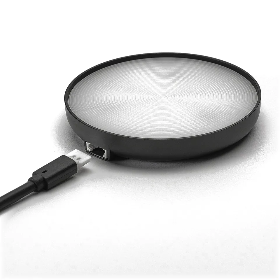 Round wireless charger with sleek black design and usb-c cable, perfect for modern tech gadgets.