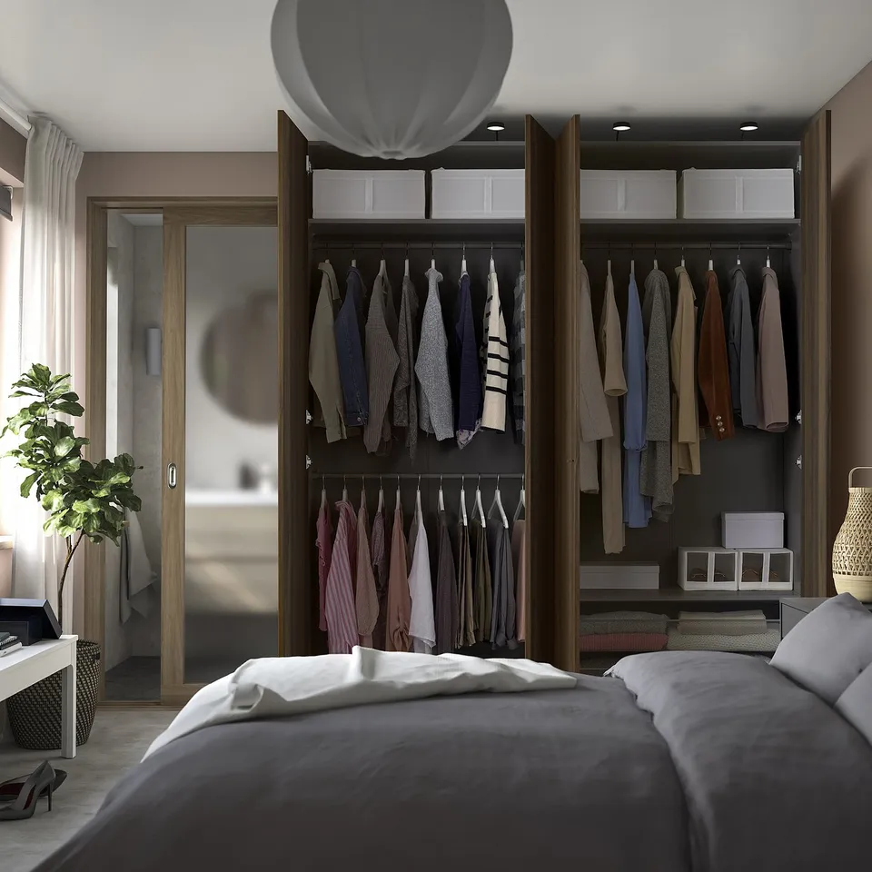 Modern bedroom with open wardrobe displaying clothes, using adjustable feet for floor levelling, and integrated dampers for soft door closure.