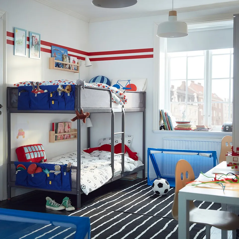 Blue bunk bed with ladder & toys in kids room.
