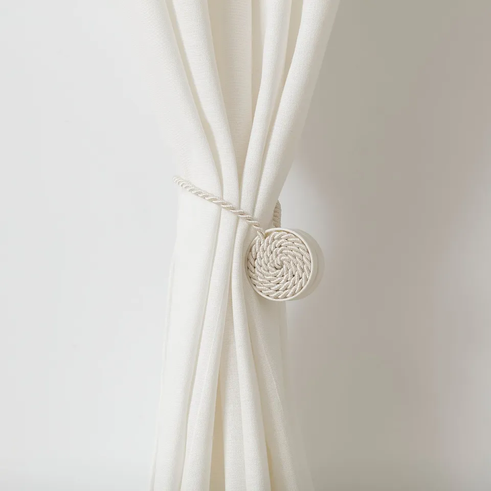 White rope-like curtain tie-back with magnetic ends for easy decoration and practical use.