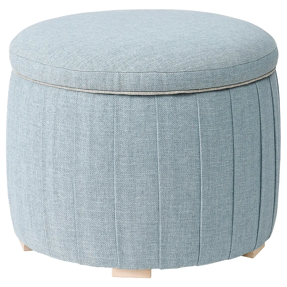Light blue cushioned round storage ottoman with wooden legs, pleated sides and piping.
