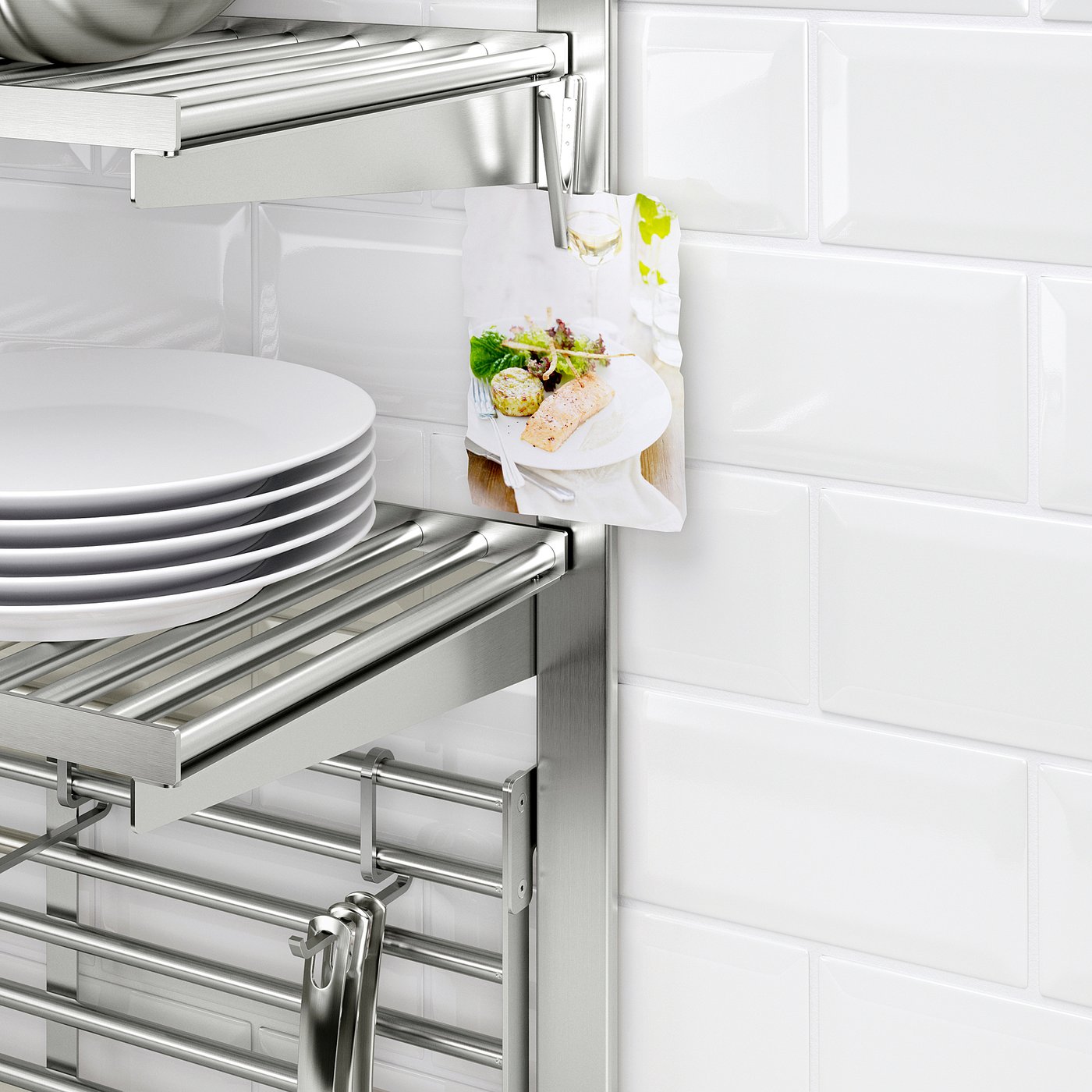 Stainless dish rack stores plates, with magnetic clips holding paper with food.