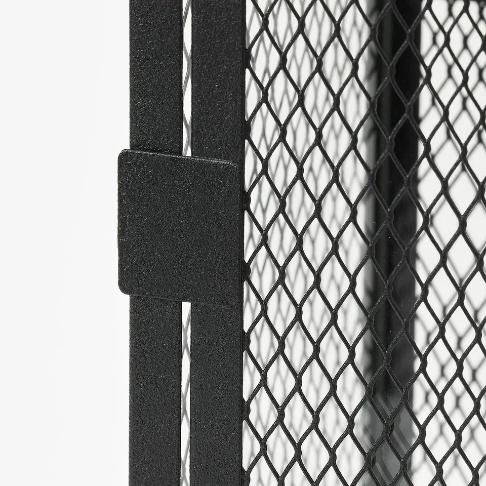 Black metal mesh candle lantern. Close-up shows intricate design and robust construction.