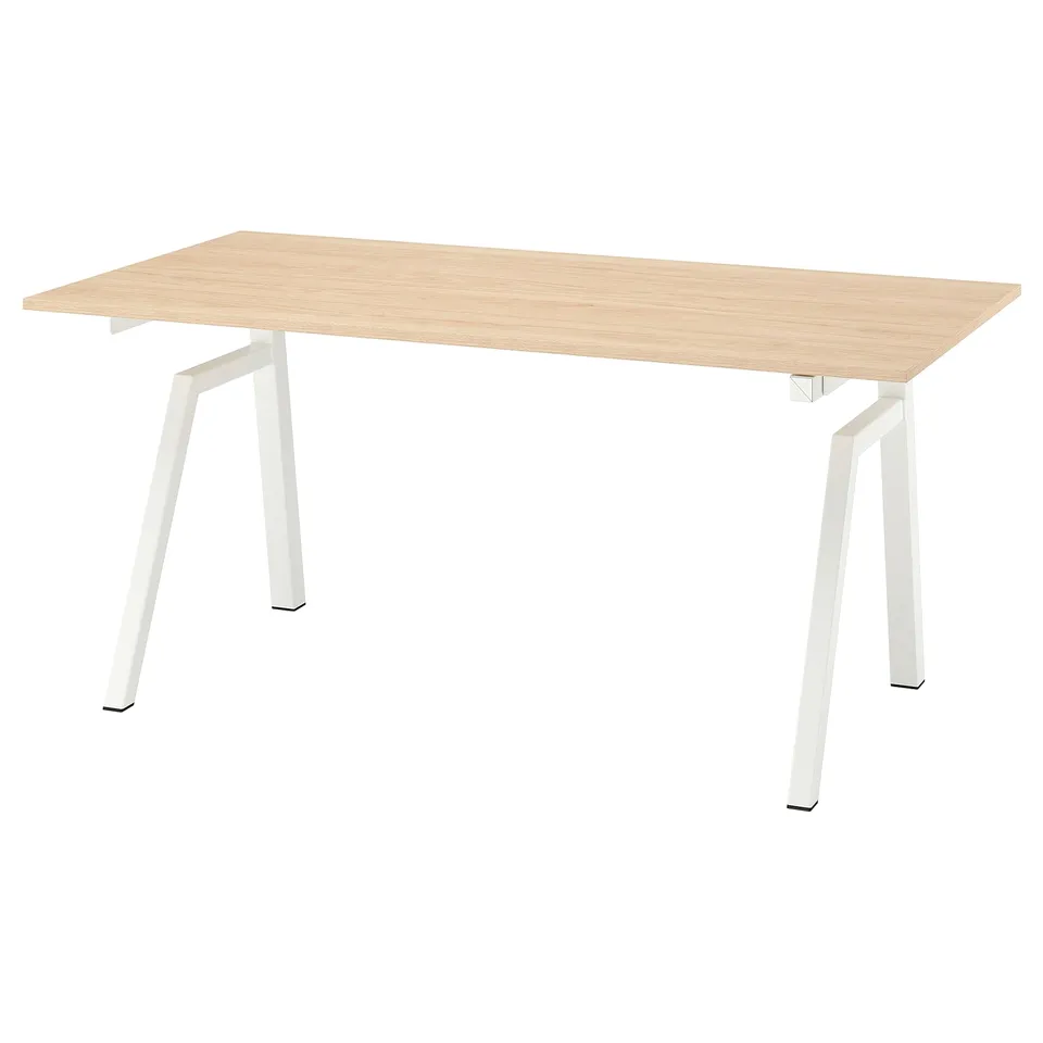 Trottén sit/stand desk, light wood top, white metal legs, modern minimalist design.
