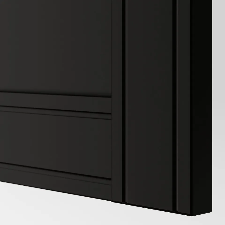 Closeup of matte black FLISBERGET cabinet door, showing smooth finish and subtle grooves.