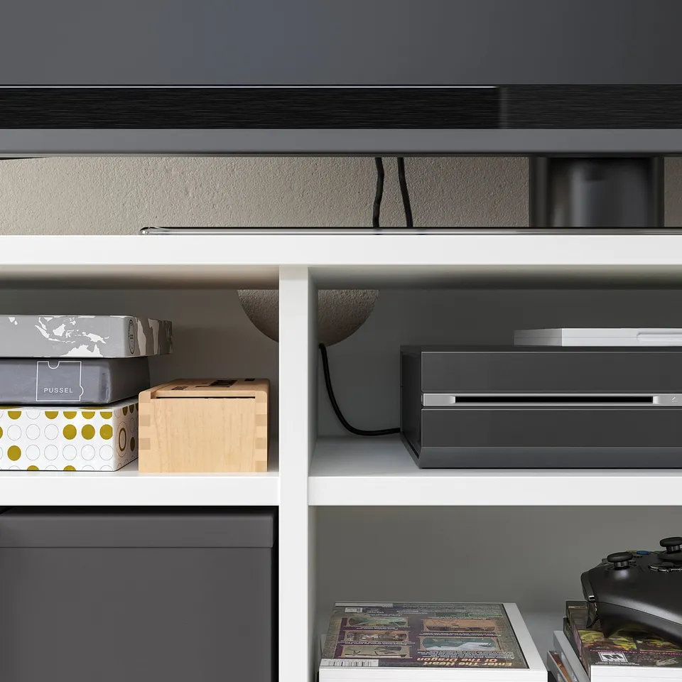 Modern grey tv stand, with open shelves & drawers, neatly organises electronics & media.