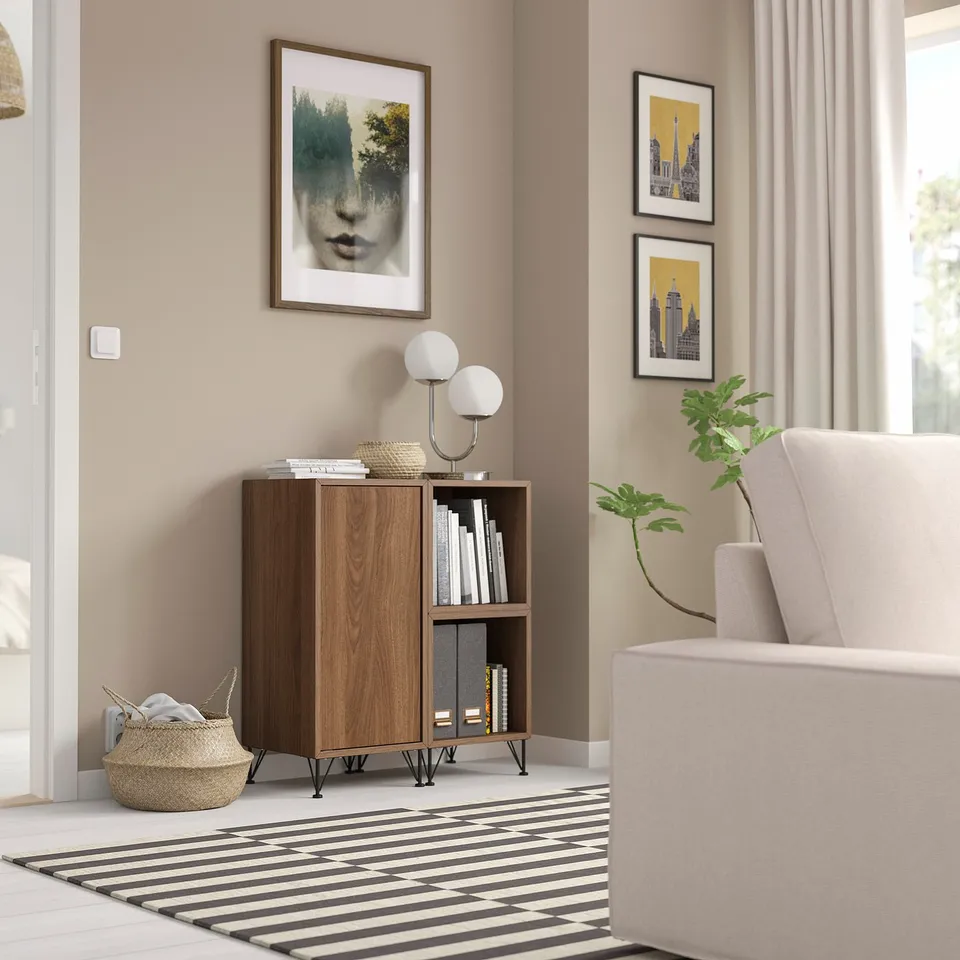 Wooden EKET storage with shelves & cabinets, decorated with lamp, rug, chair, basket, wall art, window.